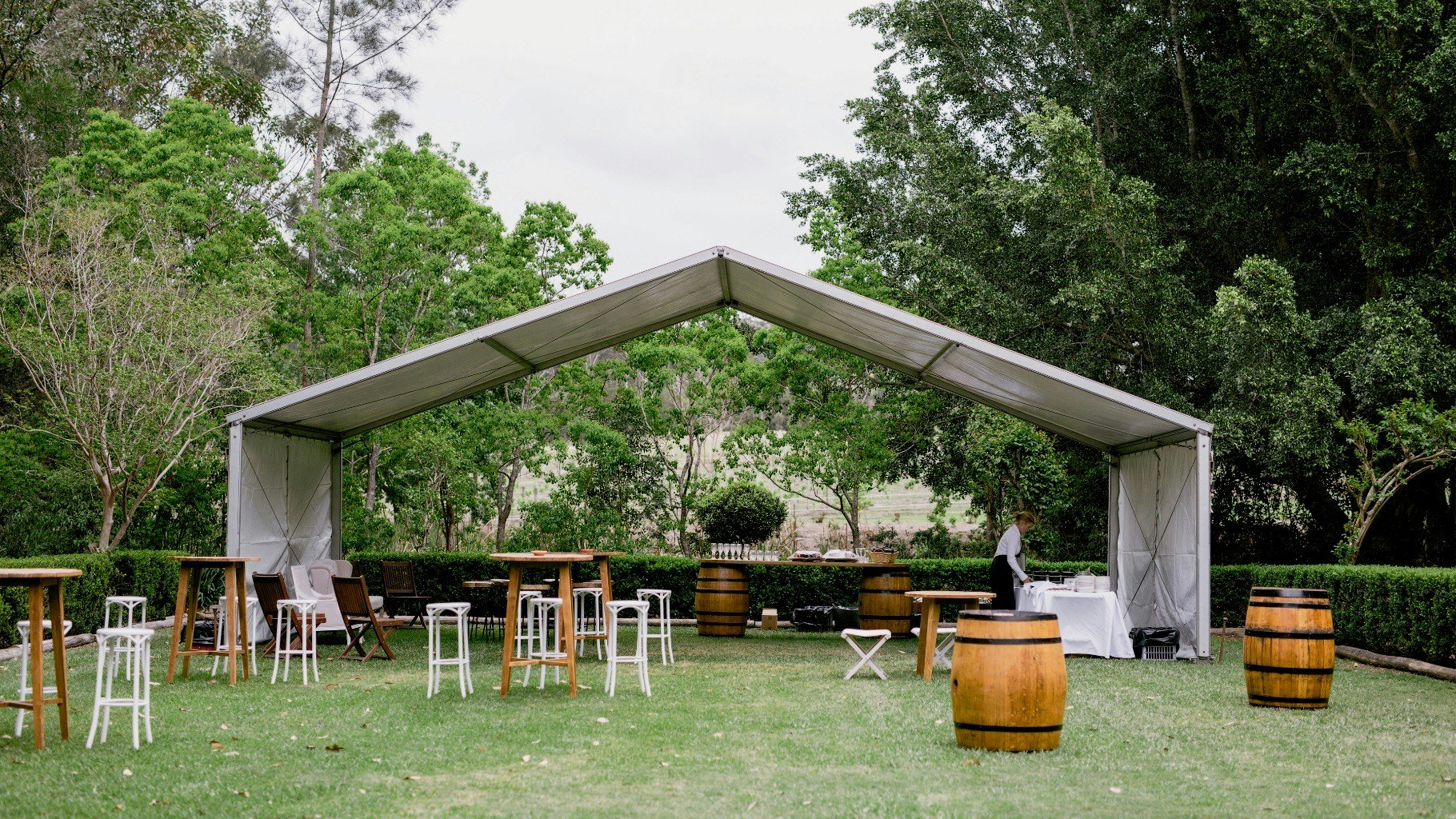 Outdoor garden marquee setup for a wedding celebration.